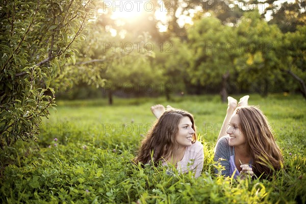 Caucasian women laying in rural field