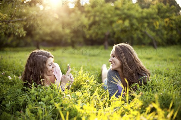 Caucasian women laying in rural field