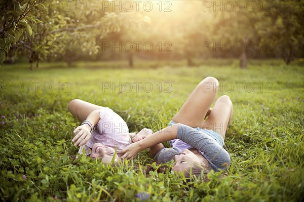 Caucasian women laying in rural field