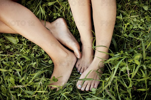 Close up of feet of Caucasian women in grass