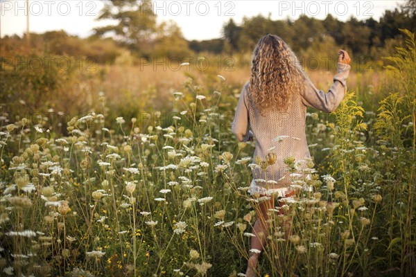 Woman walking in rural field