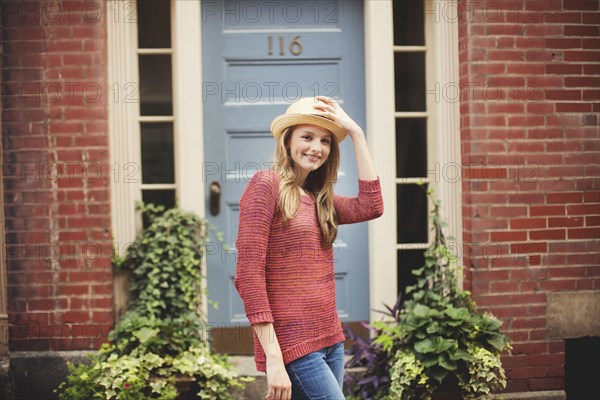 Smiling girl standing near doorway