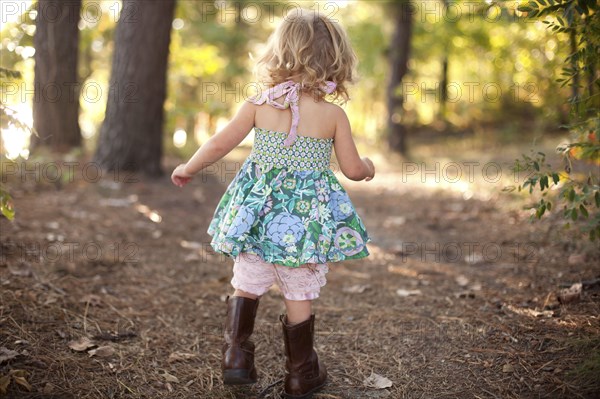 Girl walking on forest path