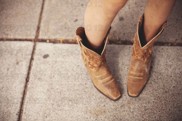 High angle view of woman wearing cowboy boots