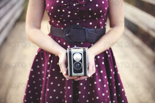 Woman photographing with vintage camera