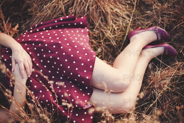 High angle view of woman laying in hay