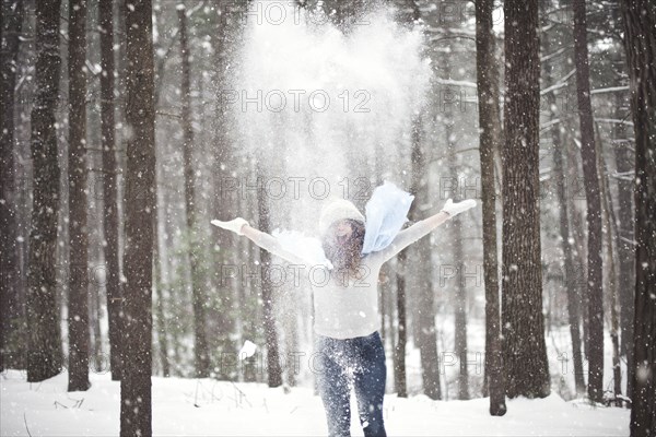 Girl playing in snowy forest