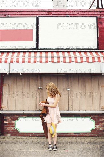 Caucasian teenage girl standing outside pizzeria