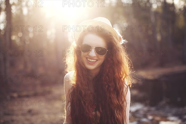 Hispanic woman walking by pond in park