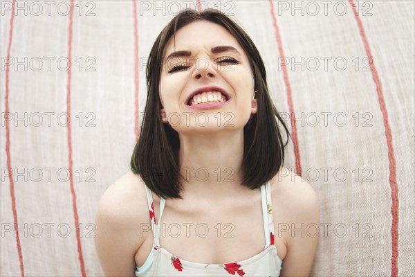 Caucasian woman grinning with bared teeth