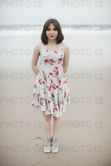 Caucasian woman standing on beach