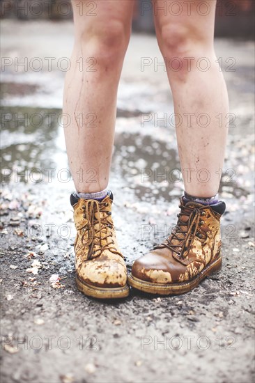 Caucasian woman wearing dirty boots