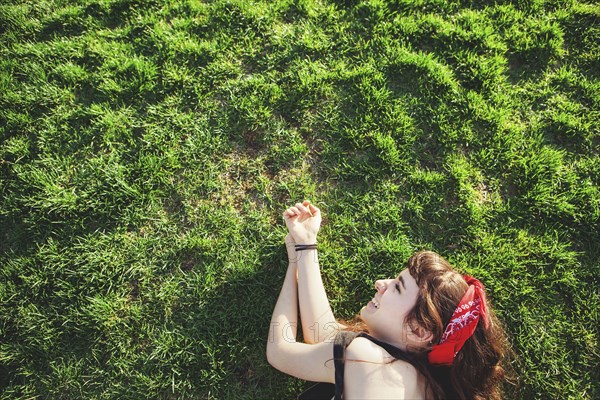 Caucasian woman laying in grass