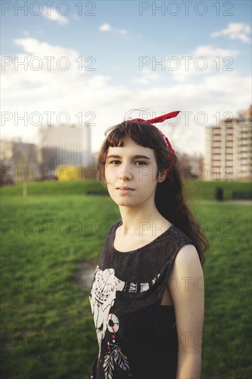 Caucasian woman standing in urban park