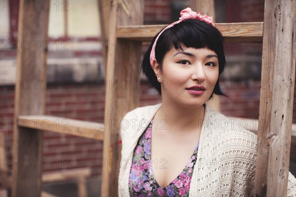 Mixed race woman standing near wooden frame