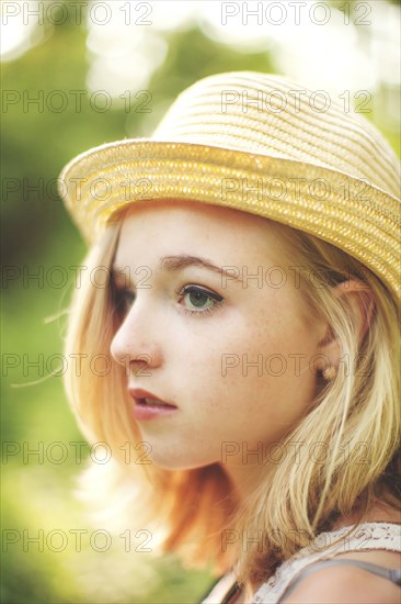 Close up of Caucasian woman wearing straw hat
