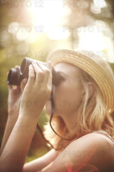 Caucasian woman looking through binoculars