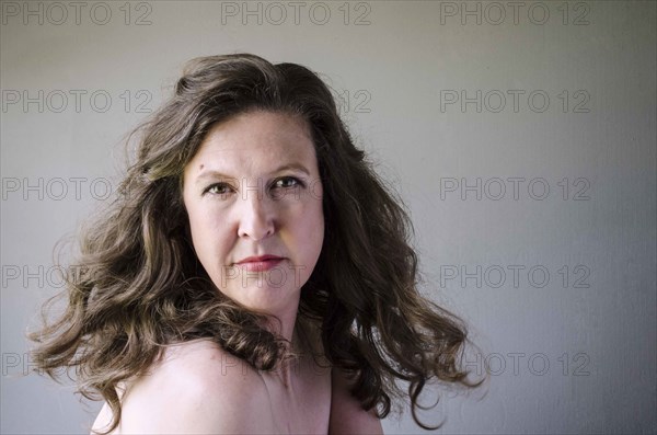 Close up of serious woman twirling hair