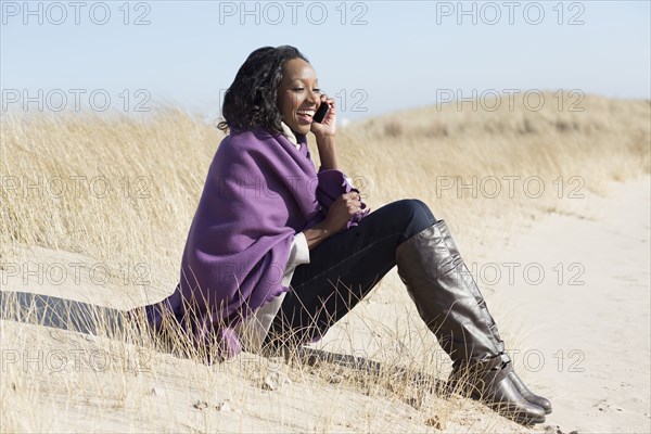 Woman talking on cell phone on beach