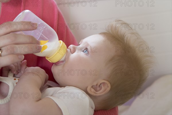 Close up of mother feeding baby girl