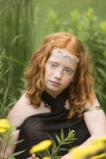 Caucasian girl wearing flower crown in garden