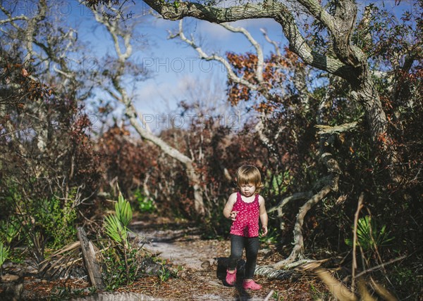 Mixed race girl walking on dirt path