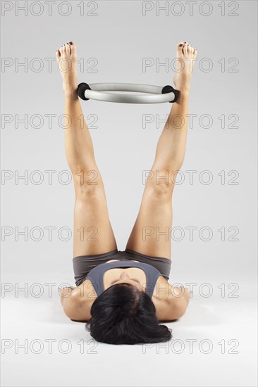 Caucasian woman exercising with resistance ring