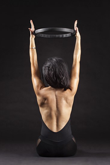 Caucasian woman exercising with resistance ring