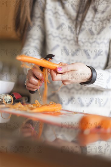 Close up of woman peeling carrot