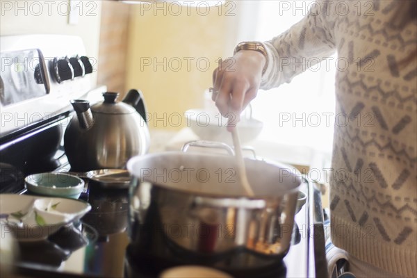 Close up of woman cooking in kitchen