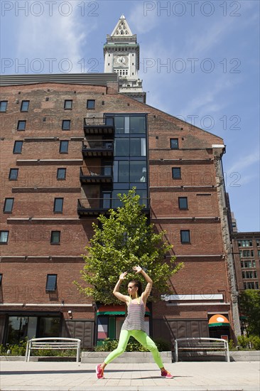 Caucasian woman posing on city sidewalk