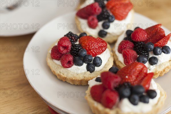 Close up of fruit and cream tarts