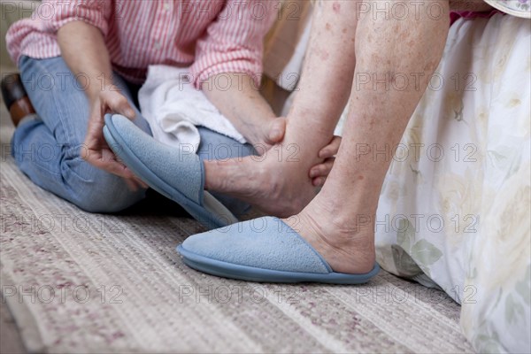 Caregiver helping older woman in home