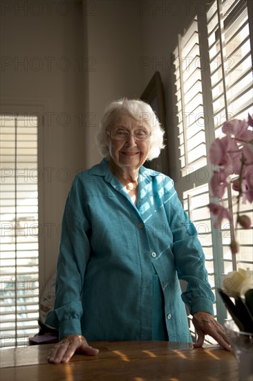 Older Caucasian woman smiling at table