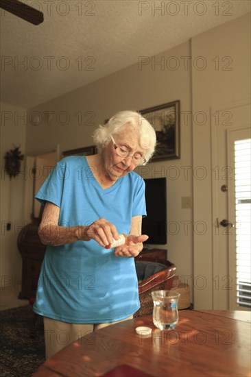 Older Caucasian woman taking medication