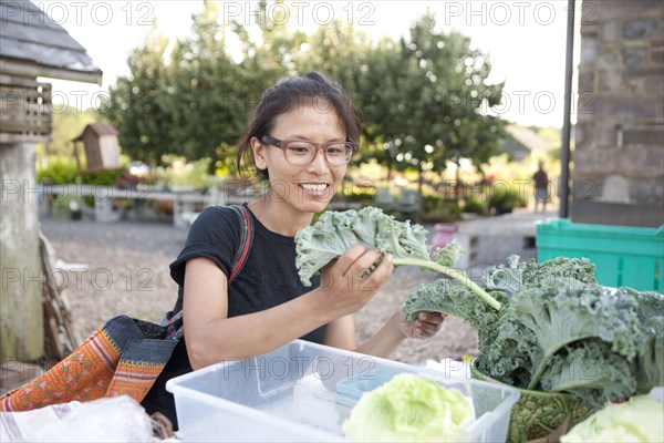 Woman shopping for greens at farmers market