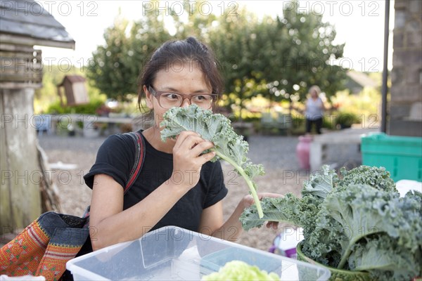 Woman shopping for greens at farmers market