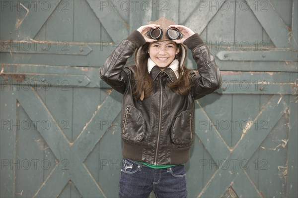 Mixed race girl wearing aviator goggles