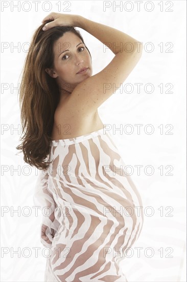 Side view of pregnant woman wearing bodysuit