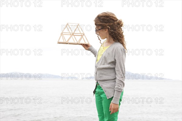 Caucasian girl examining project