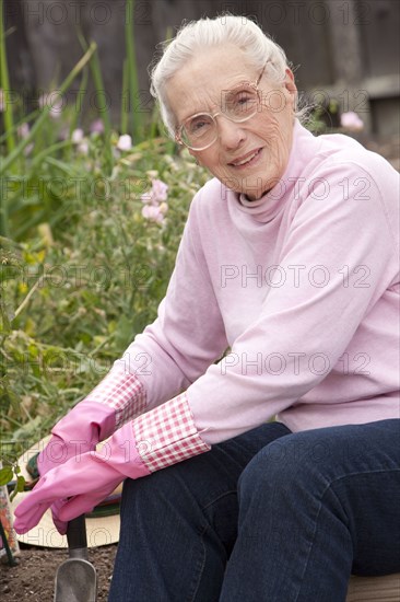 Older Caucasian woman sitting in garden