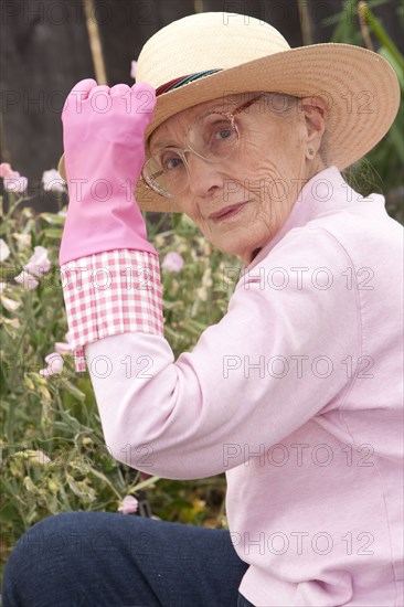 Older Caucasian woman sitting in garden