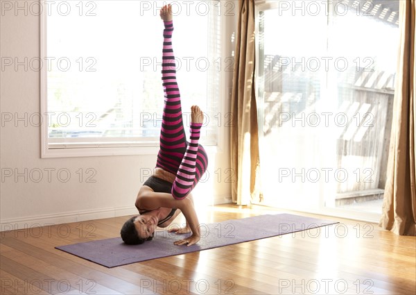 Woman practicing yoga in studio