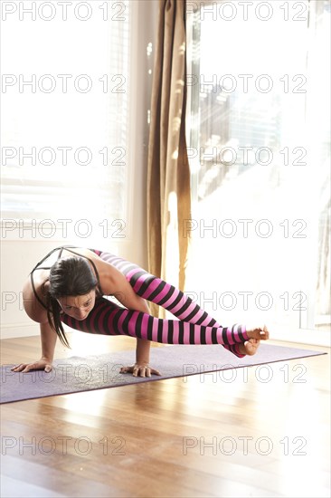 Woman practicing yoga in studio