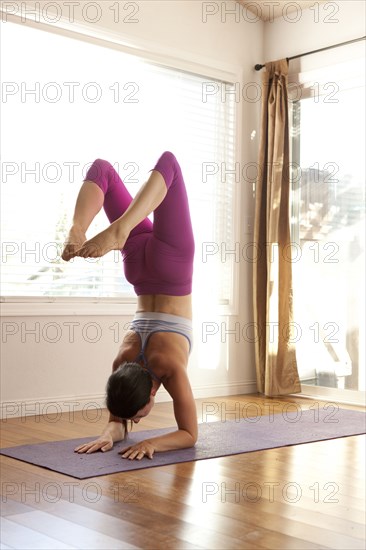 Woman practicing yoga in studio