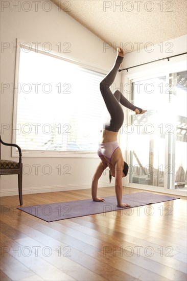 Woman practicing yoga in studio