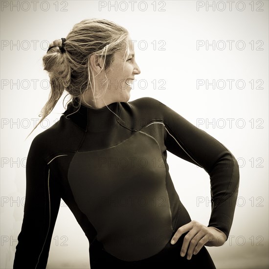 Smiling Caucasian woman wearing wetsuit