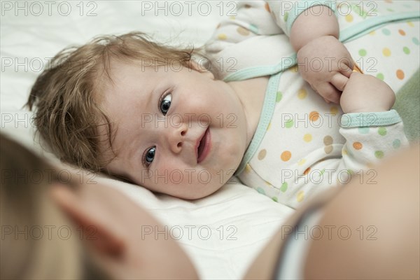 Caucasian mother and daughter laying on bed