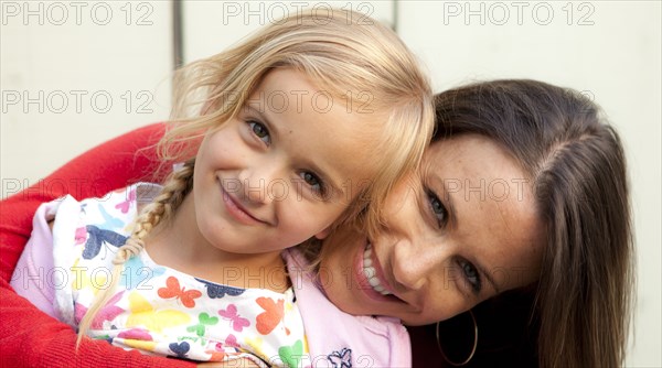Caucasian mother and daughter smiling outdoors