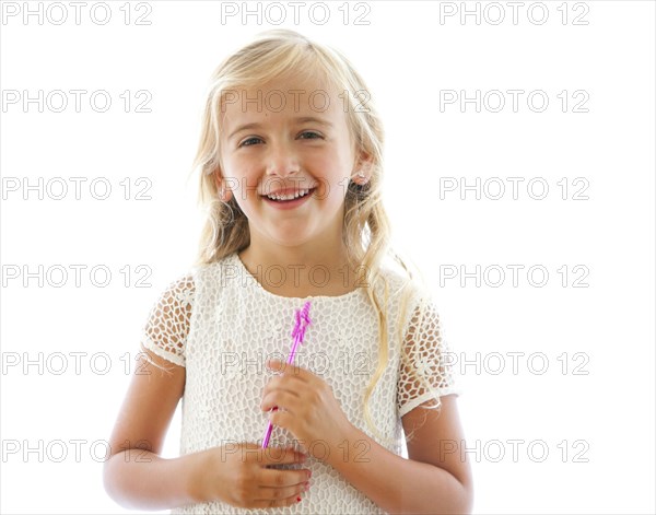 Smiling Caucasian girl holding fairy wand